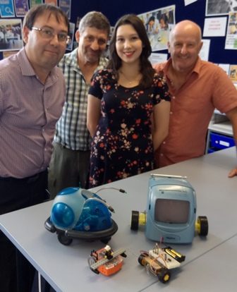 A school robotics team with their robots